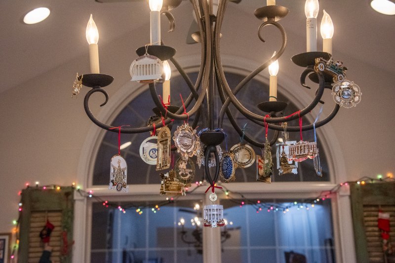White House Christmas ornaments decorate the chandelier in the home of Lisa and Tom Malone in Wagamons West Shores.